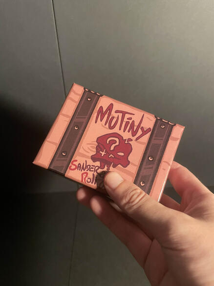 Mutiny box held up close with a slight tilt.